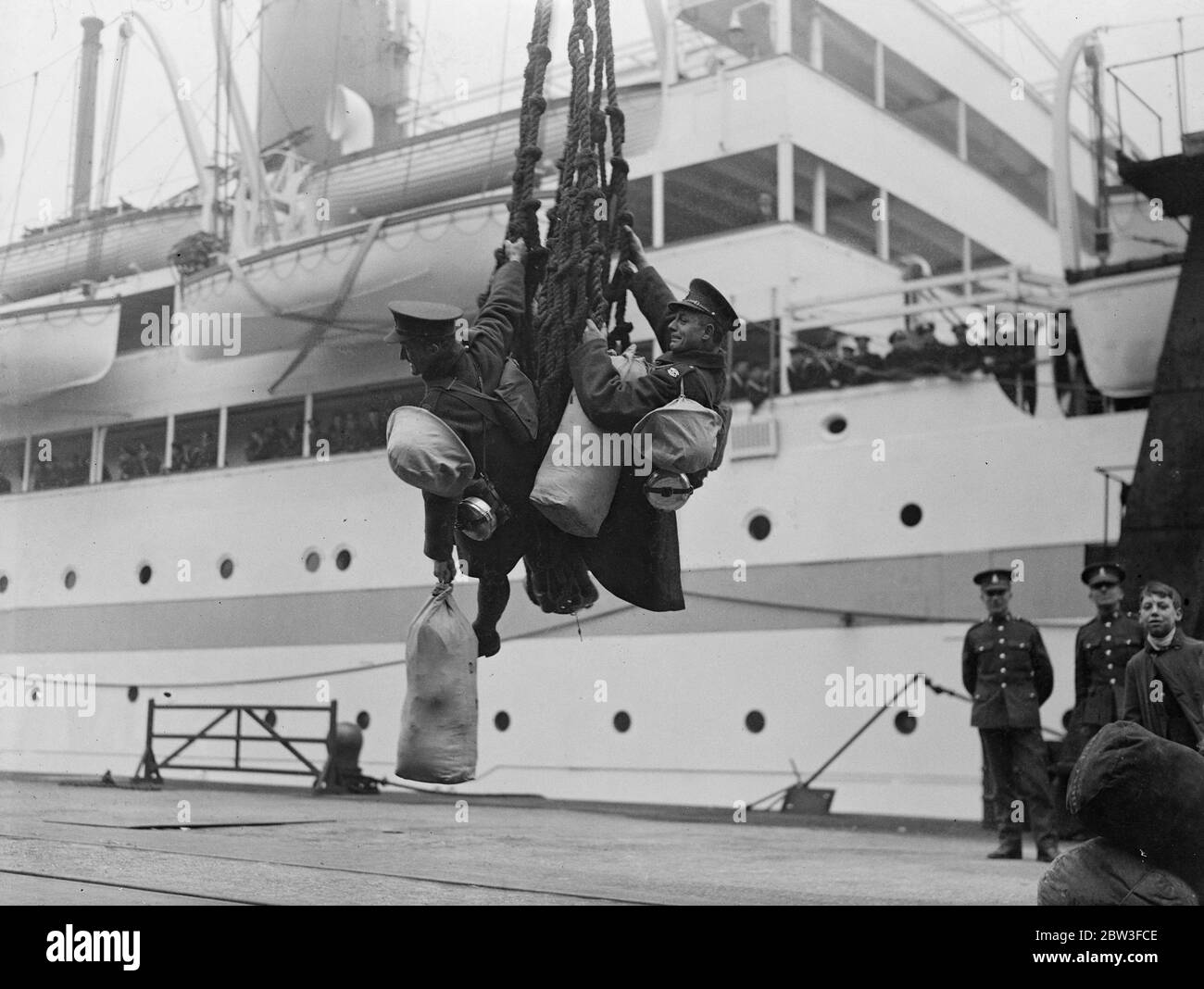 Soldiers nearly miss the boat , hanging on to net in mid air . Soldiers going to the Far East from Southampton Docks . 19 January 1935 Stock Photo
