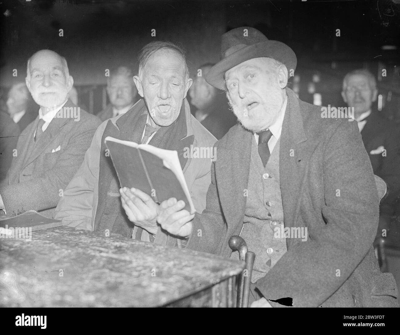 Boys of the ' Old Brigade ' to broadcast ' Grandfathers Club ' on the air ( radio ) . Photo show ; Mr J Siscer , aged 82 ( left ) and Mr C J Eddy , aged 80 ( right ) , two of the oldest members of the choir rehearsing for their broadcast at Holloway . 25 January 1935 Stock Photo