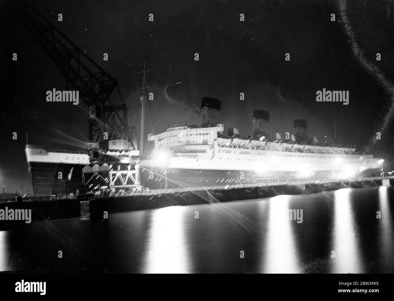 Beauty of the Queen Mary under floodlights . The Queen Mary floodlighted in King George V drydock at Southampton . 28 March 1935 Stock Photo