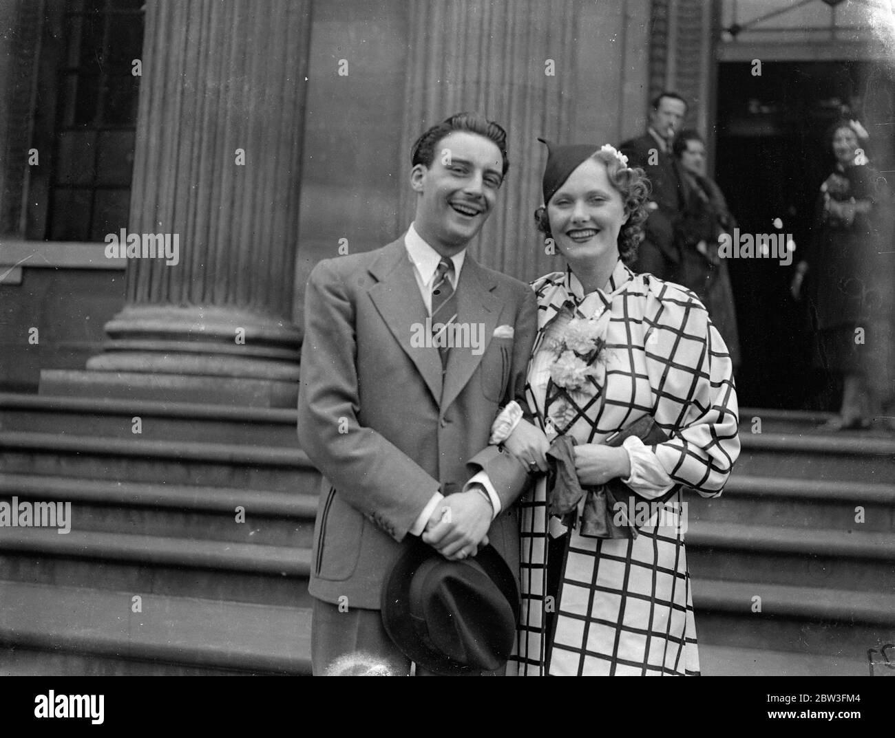 Scenario writer weds dancer at London register office . Mr Val Guest , the scenario writer who wrote ' Public Nuisance No 1 ' , was married at Marylebone Register Office to Miss Pat Watson , a dancer appearing in ' Seeing Stars ' at the Gaiety Theatre . the couple met a few weeks ago in a film studio . Photo shows , the bride and groom . 25 March 1936 Stock Photo