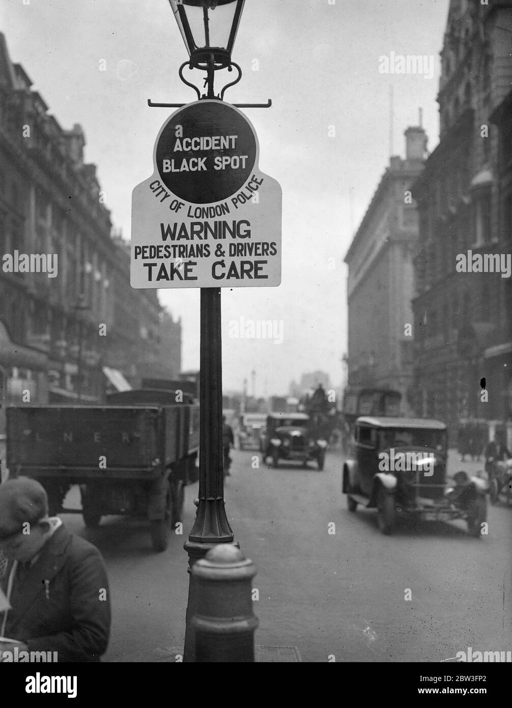 City accident ' Black Spots ' , labelled in new drive against road casualties . Black circles bearing the grim announcement ' Accident Black Spot ' have been erected on lamp standards in New Bridge Street , E C . They also bear the admonition ' Pedestrians and drivers take care . These notices are to be erected at other danger spots in the city as part of the Ministry of Transport ' s new drive against road casualties . Photo shows , the ' Black Spot ' , notice on a lamp standard in New Bridge Street . 31 March 1936 Stock Photo