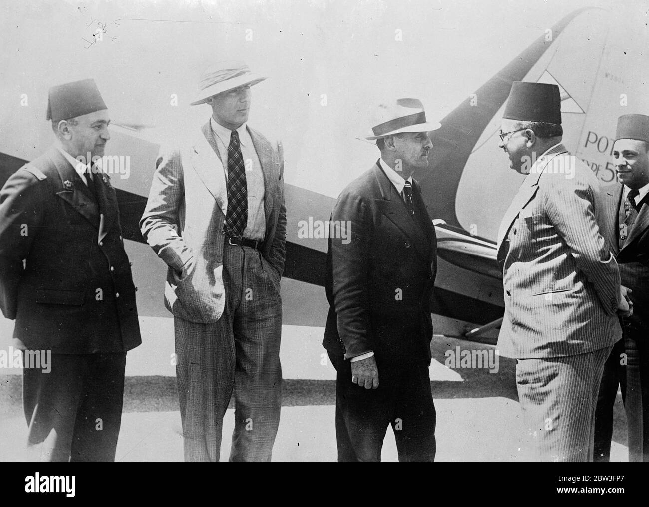 Romania ' s flying prince arrives in Cairo after flight from Bucharest . Making the flight in his private plane Prince George Bibesco of Romania arrived in Cairo from Bucharest , accompaniedby Prince Contacuzens . Prince Bibesco is well known in aeronautical circles throughout the world . Photo shows , Prince George Bibesco ( right soft hat ) , Prince Contecuzene welcomed on arrival at Cairo . 31 March 1936 Stock Photo