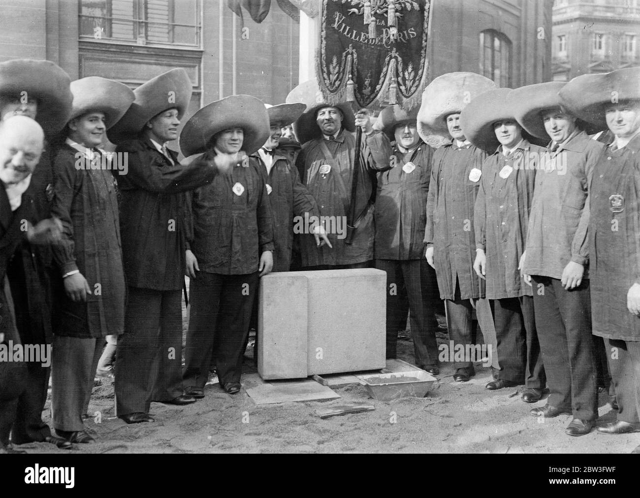 Picturesque ceremony in Paris market . A thousand homeless persons were fed following the laying of the corner stone for a new market building at Les Halles , Paris . Photo shows , market porters in their large hats at the ceremony . 3 February 1935 Stock Photo