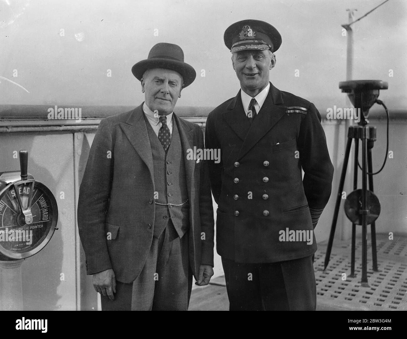 Queen Mary 's  commander arrives in London . Captain Sir Edgar Britten congratulated by Captain Irving of the Majestic aboard the Majestic at Southampton . 27 November 1935 Stock Photo