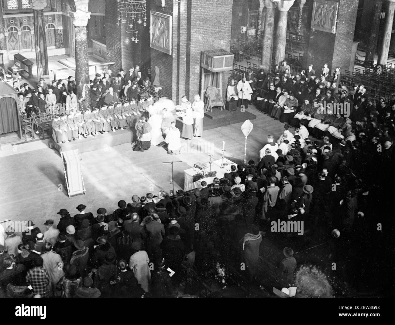 Cardinal Hinsley washes feet of 12 choirboys at Westminster Cathedral . Cardinal Hinsley , Roman Catholic Archbishop of Westminster washed the feet of 12 choirboys at Westminster Cathedral , London , during the Easter Mondation ceremony . This commemorates the act of the Saviour in washing the feet of the apostles . Photo shows a general view of the ceremony showing Cardinal Hinsley washing the choirboys feet . 10 April 1936 Stock Photo
