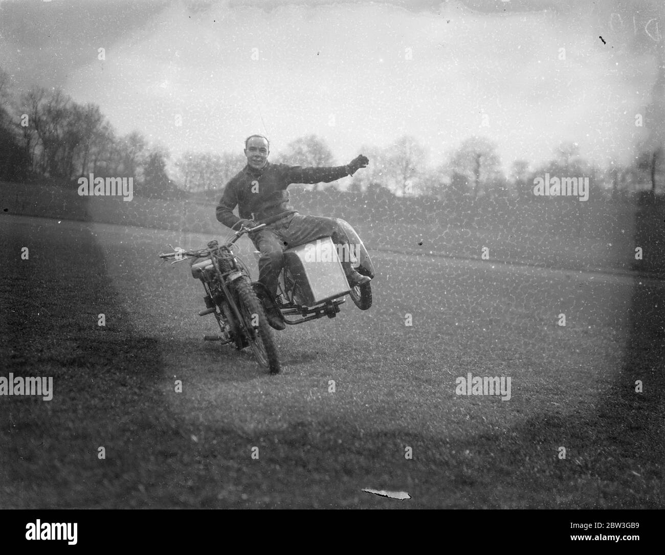 Mid air motor cyclist . Riders rehearse Easter Monday thrills at Crystal Palace . Many well known dirt track and trials riders are rehearsing at the Crystal Palace , London , for the Easter Monday , motor cycle , gymkhana . Photo shows , Tris Sharpe performs tricks on his motorcycle . 8 April 1936 Stock Photo