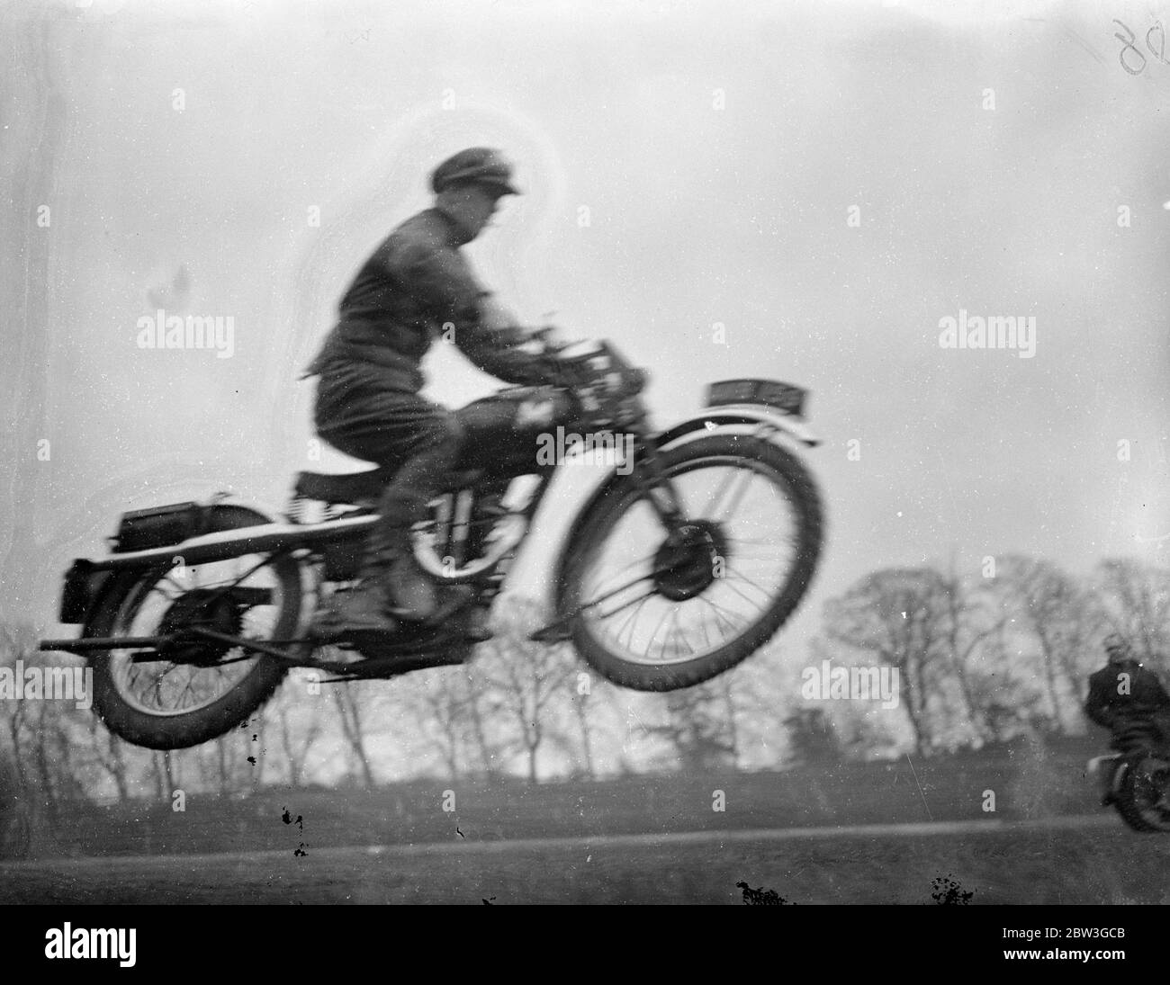 Mid air motor cyclist . Riders rehearse Easter Monday thrills at Crystal Palace . Many well known dirt track and trials riders are rehearsing at the Crystal Palace , London , for the Easter Monday , motor cycle , gymkhana . Photo shows , Nobby Clarke , the well known trials rider , in mid air as he rehearsed a motor cycle jump at the Crystal Palace . 8 April 1936 Stock Photo