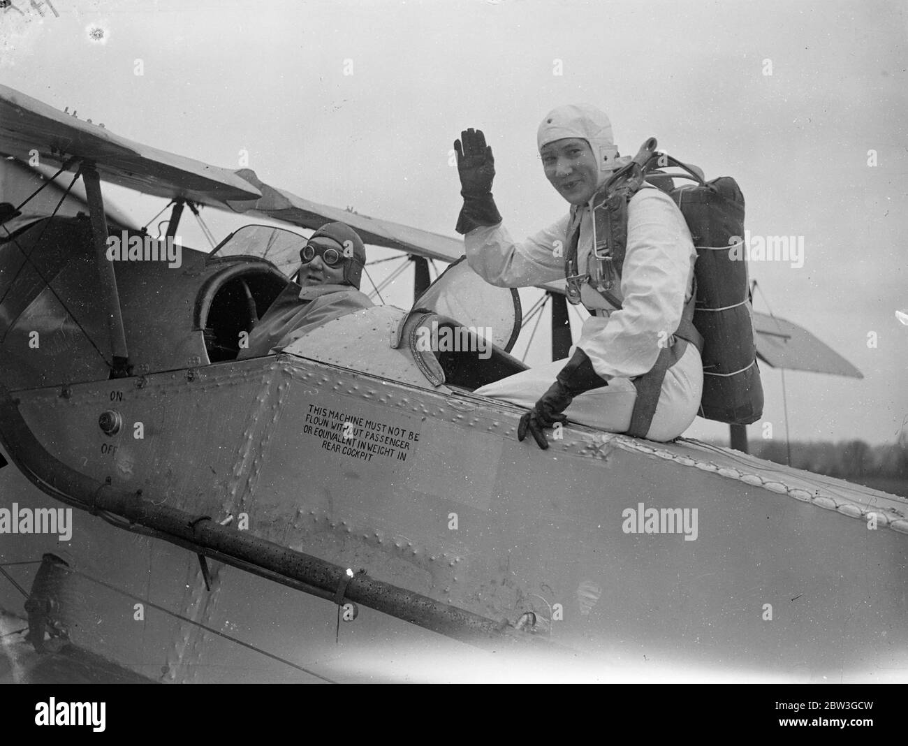 21 year old girl qualifies to become Britain ' s youngest professional parachutist . Miss Josephine Nadin , a 21 year Derby girl , underwent the last part of her Air Ministry test at Broxbourne Aerodrome , Herts to become Britain ' s youngest professional parachutist . Miss Hadin had already successfully accomplished six jumps , and at Broxbourne had four more to do in order to satisfy the Air Ministry officials , as the test comprises ten jumps . Photo shows , Miss Josephine Nadia is seen waving from the rear cockpit before taking off at Broxbourne . 6 April 1936 Stock Photo