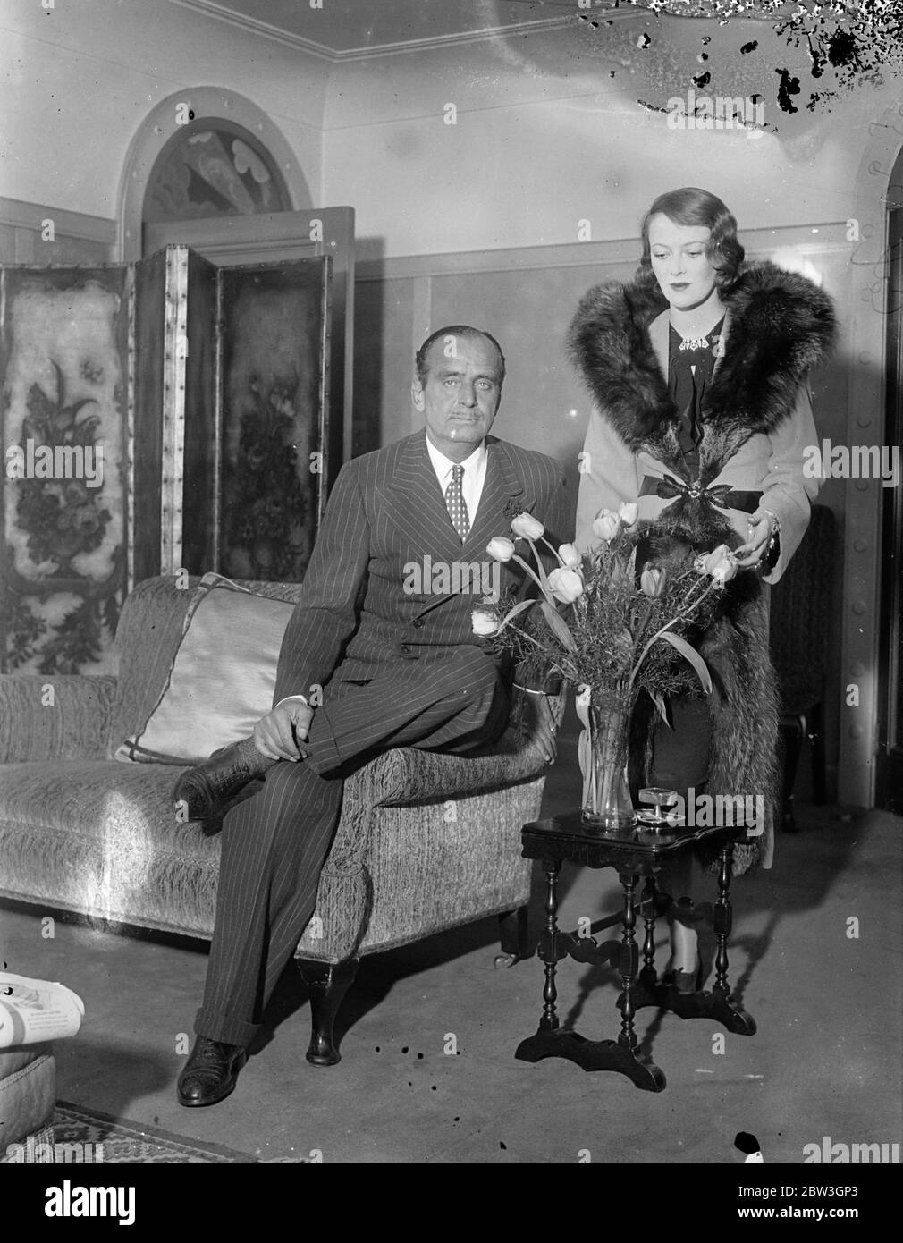 Douglas Fairbanks and his wife return to London after honeymoon . Douglas Fairbanks photographed with his wife at his London hotel . 20 March 1935 Stock Photo