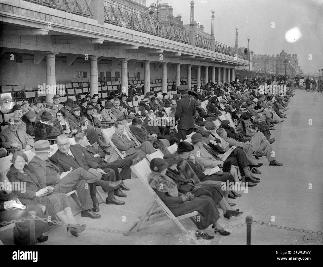 Spring sunshine attracts thousands to Eastbourne . Basking in the Spring sunshine on the front at Eastbourne . 22 March 1935 Stock Photo