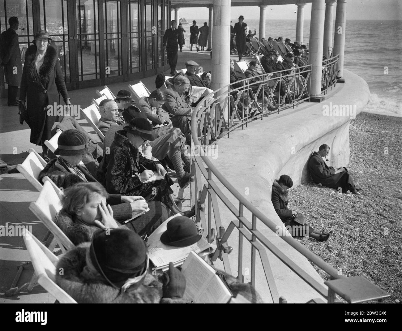 Spring sunshine attracts thousands to Eastbourne . Basking in the Spring sunshine on the front at Eastbourne . 22 March 1935 Stock Photo