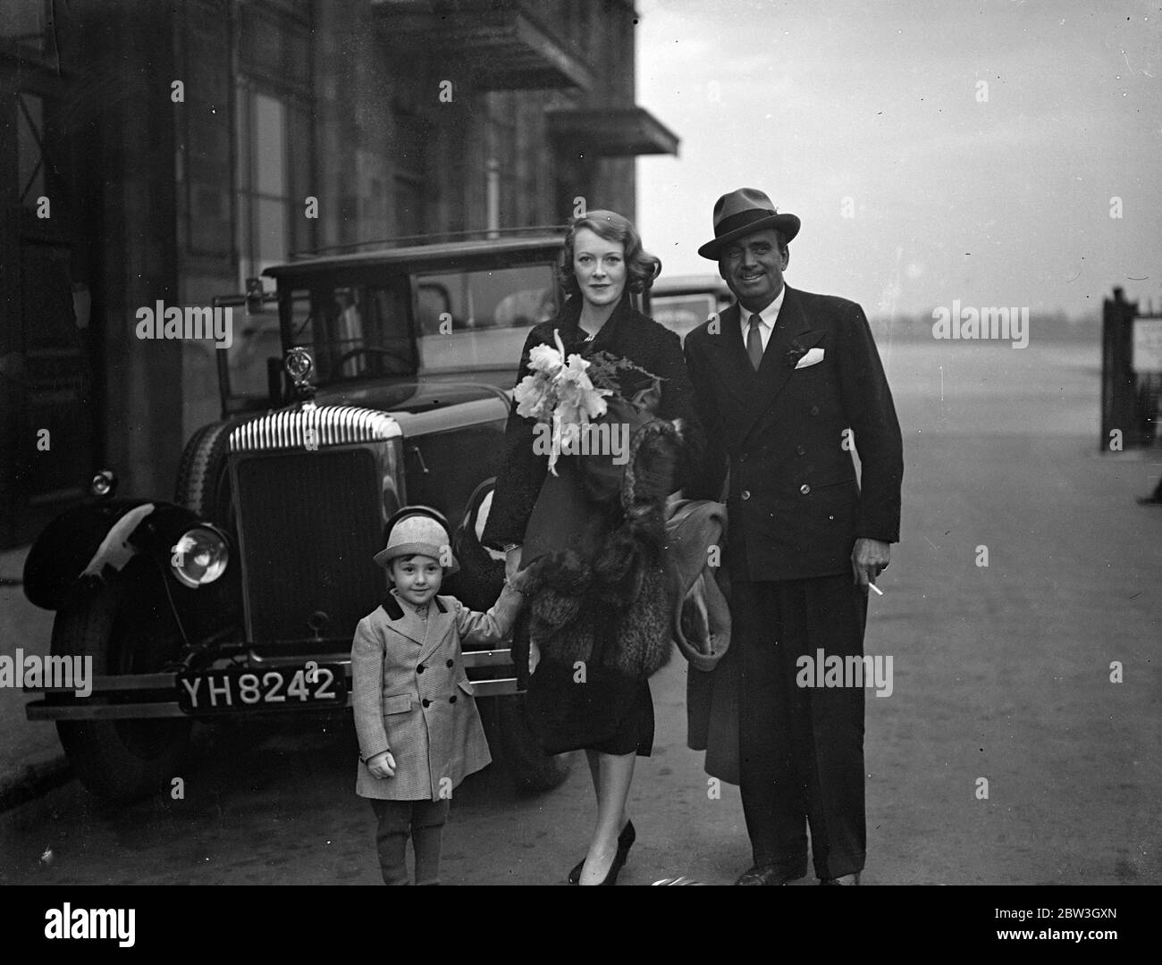 Douglas Fairbanks and wife arrive by air after honeymoon in Spain . Douglas Fairbanks , the film actor , and his bride , the former Lady Ashley who were recently married secretly in Paris , arrived at Croydon by air after their honeymoon in Spain . Photo shows , Douglas Fairbanks and his wife photographed with Thomas Michael Black , Mrs Fairbanks nephew , on arrival at Croydon . 18 March 1936 Stock Photo