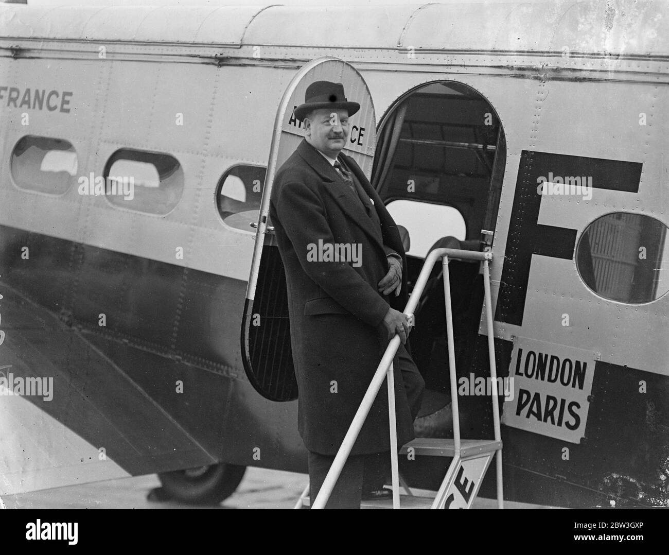 M Flandin leaves to report to French Government on Germany ' s statement to League . M Flandin , French Foreign Minister , left Croydon by air for Paris to report to his Government on Herr von Ribbentrop , Hitler ' s representative told the Council . ' We consider the Locarno Treaty as being dead , and that not by the fault of Germany . Photo shows , M Flandin walking to the plane at Croydon . 19 March 1936 Stock Photo