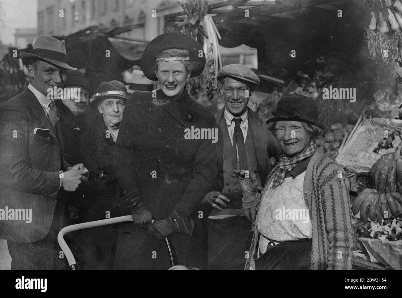 Socialist daughter in law of peer starts election campaign in St George's , Westminster . The Hon Mrs Christopher Fremantle canvassing stall holders in Lupus Street , with her son , Adam . 25 October 1935 Stock Photo