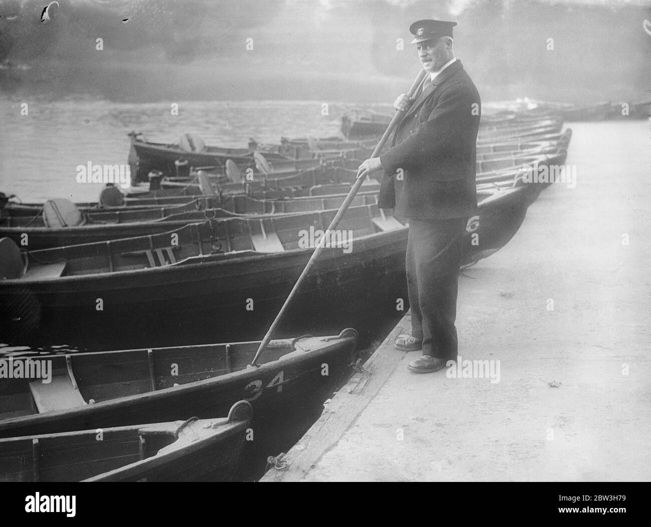 London boatman retiring after 46 years . Mr Charlie Potter with his boats in Victoria Park . 26 October 1935 Stock Photo