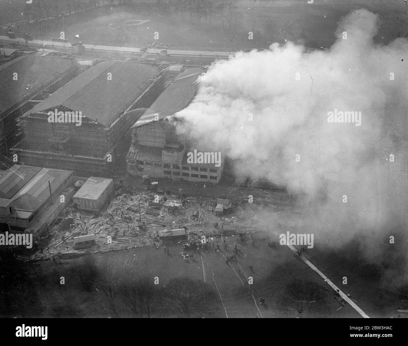 Fire rages at new Denham film studios , Buckinghamshire . An aerial view of the blazing studio . 17 March 1935 Stock Photo