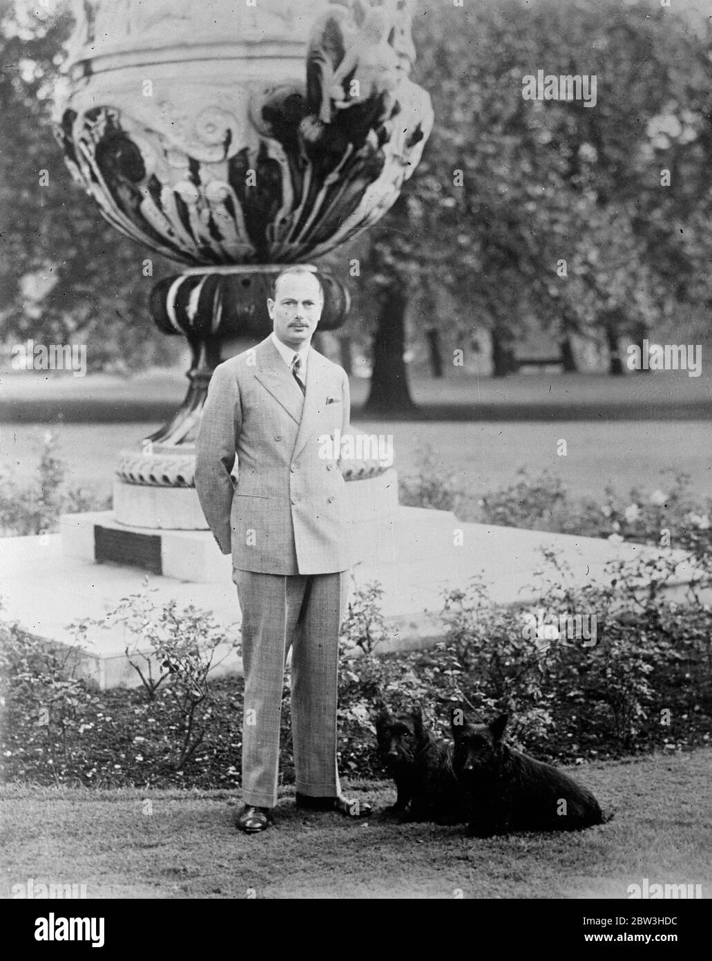 Duke of Gloucester ' s 36 birthday . Accompanied by the Duchess , the Duke is lunching with King Edward and Queen Mary at Buckingham Palace . Photo shows , a picture just released of the Duke of Gloucester with two dogs in the grounds of Buckingham Palace . 31 March 1936 Stock Photo