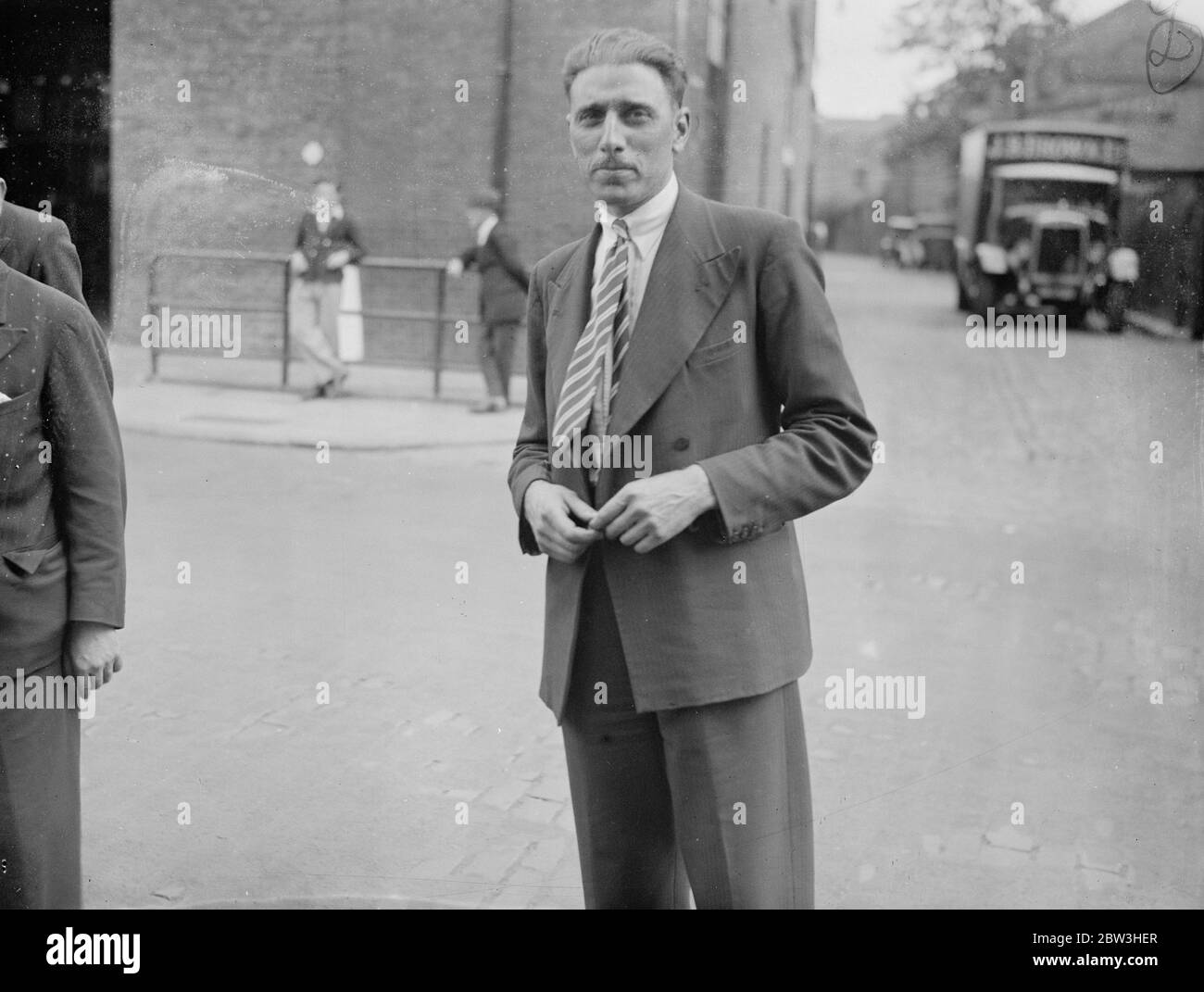 Thousands of London transport workers strike following dismissal of two men . Photo shows , Mr C R Omney , the conductor who was dismissed and later reinstated ( right ) discusseses the situation outside the Nunhead garage . 2 July 1935 Stock Photo