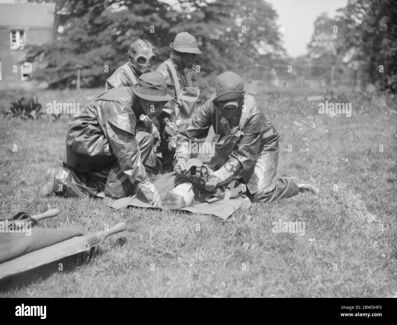 Seven Hundred and fifty Red Cross , VAD ' s take part in anti - gas exercises near Winchester . Photo shows: Nurses in gas masks help assisting casualties 21 May 1935 Stock Photo