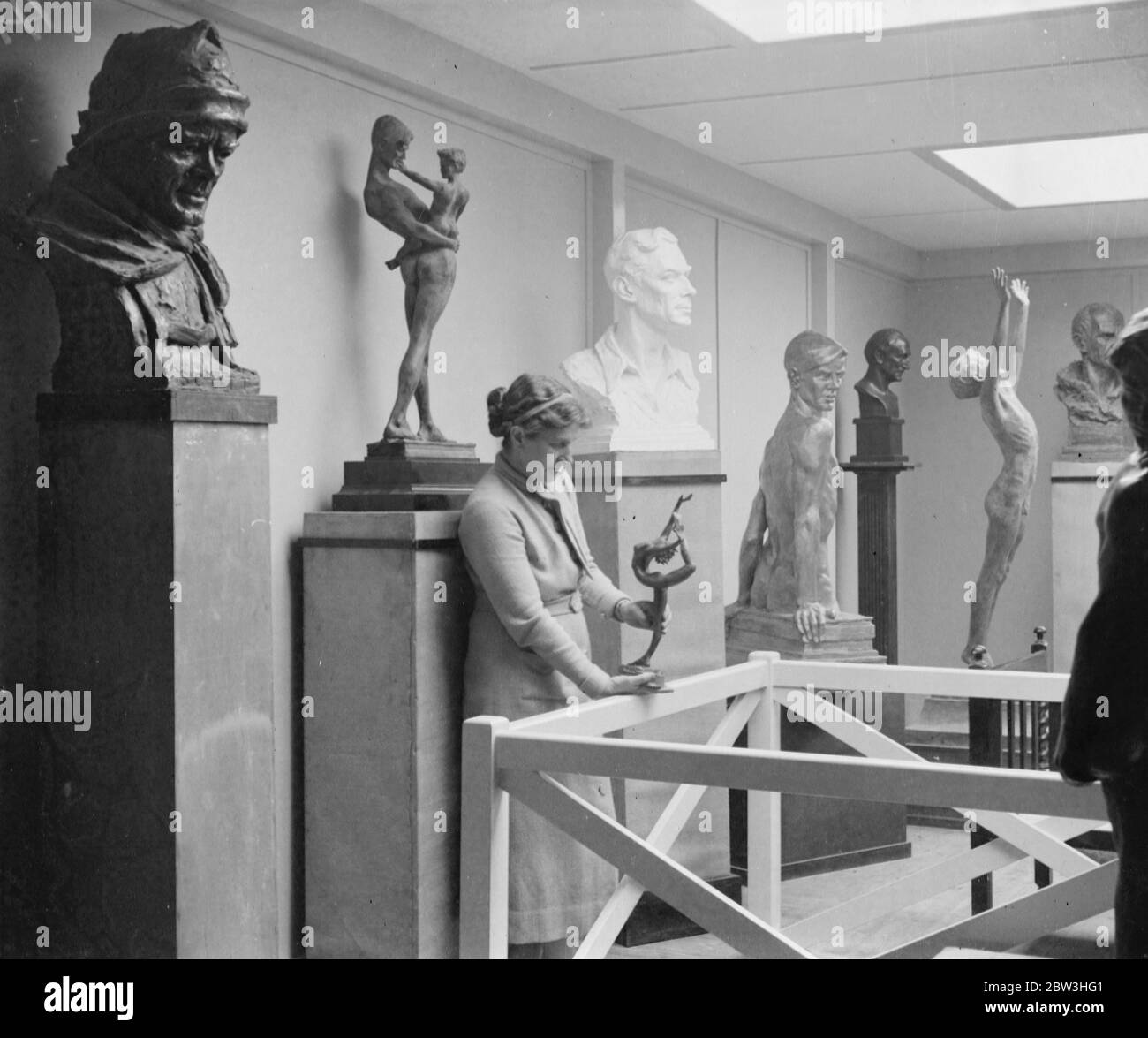 Lady Hilton Young to make jubilee bust of the King . Lady Hilton Young with some of her recent works at her London studio . On left in the foreground is a bust of Captain Scott , the explorer , who was Lady Young ' s first husband . Centre is a bust of the Duke of York . 12 February 1935 Stock Photo