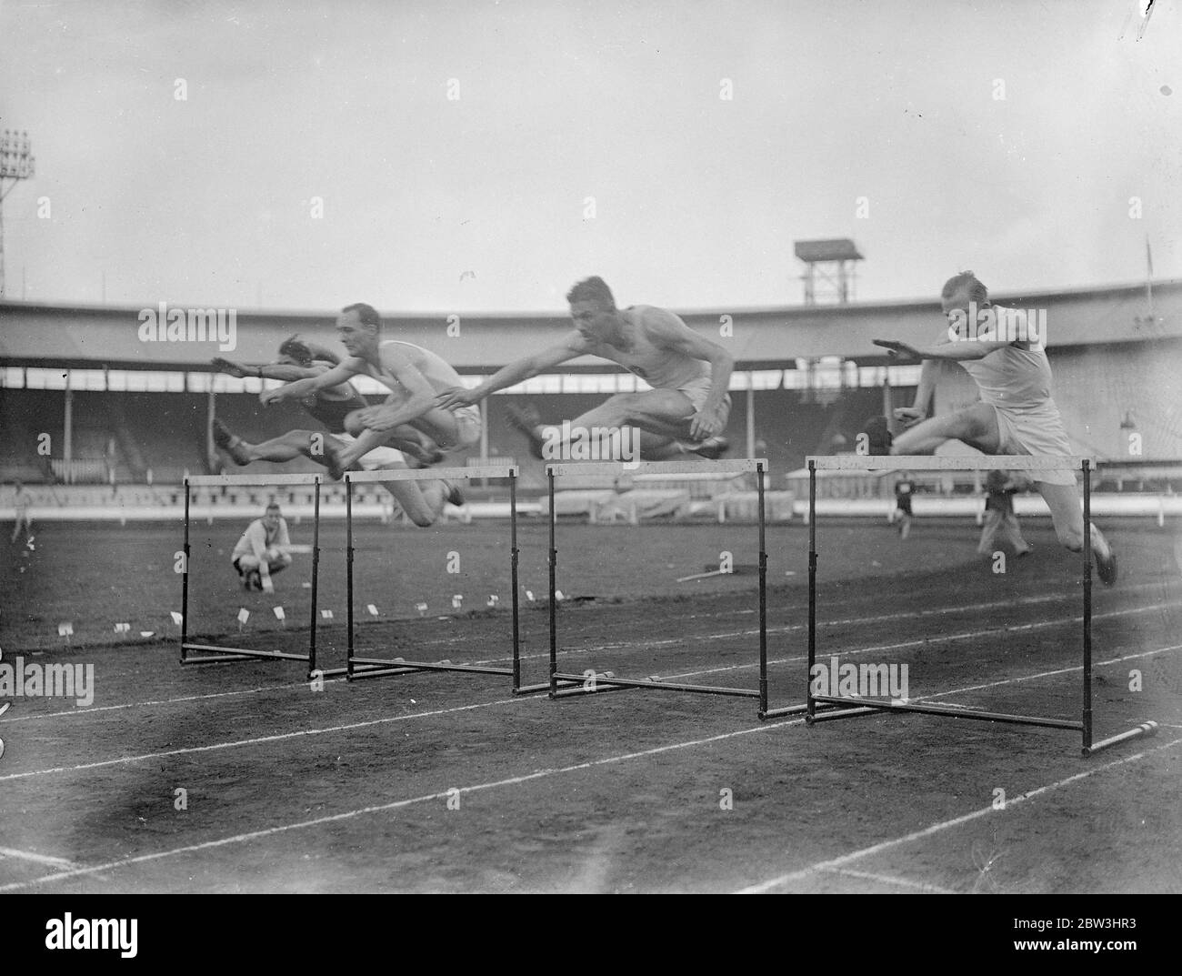Olympic Champions In The Air Exhibition At Police Sports . Four members of the British Olympic Games team to compete in Berlin next month gave an exibition at the City of London Police Athletic Club annual sports at the White City , London . Photo shows : ( left to right ) I . S . Ivanovic ; J . P . Gabriel ; D . O . Finlay captain of the British team and St . D . Thornton taking a flight of hurdles during their exhibition . 25 Jul 1936 Stock Photo