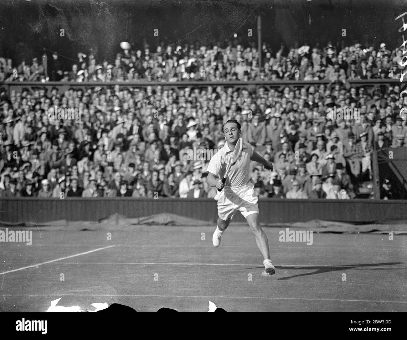 Fred Perry scores second win for England in Davis Cup . Defeats Adrian Quist . Following Austin ' s defeat of Crawford Fred Perry beat A K Quist of Australia 6-1 , 4-6 , 7-5 , 6-2 in the singles of the Davis Cup Challenge Round between England and Australia at Wimbledon . Rain interrupted play many times . Photo shows , Adrian Quist in play against Fred Perry on the Centre Court . 25 July 1936 Stock Photo