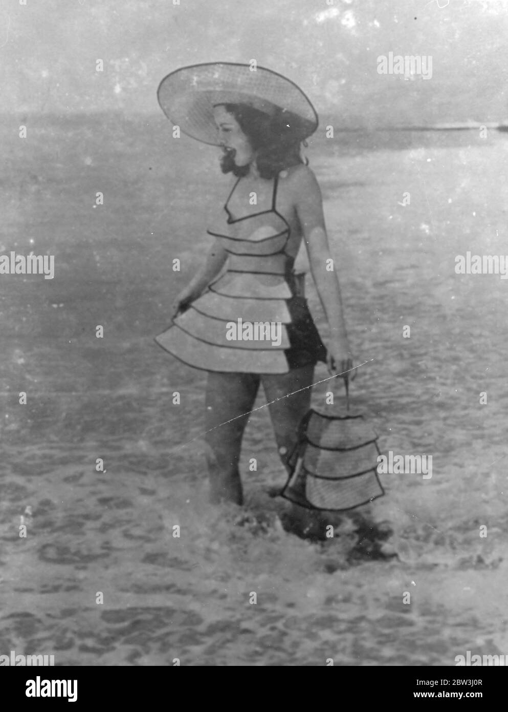 Pagoda  Bathing Fashion . Woven Wood New Material For Costumes Design By Former Airwoman . Timid bathers along the California coast need no longer fear the sea , for the latest costumes keep the swimmer afloat . Made in a new material known as woven wood , the costumes are designed by Miss Elvy Kalep , the Esthonian airwoman who became a dress designer . Extremely light , the material has taken the coast by storm and is being used for many articles of women ' s wear . Photo shows : Margaret Sinclair , the British actress who recently arrived in Hollywood from Shanghai , wearing the new woven w Stock Photo