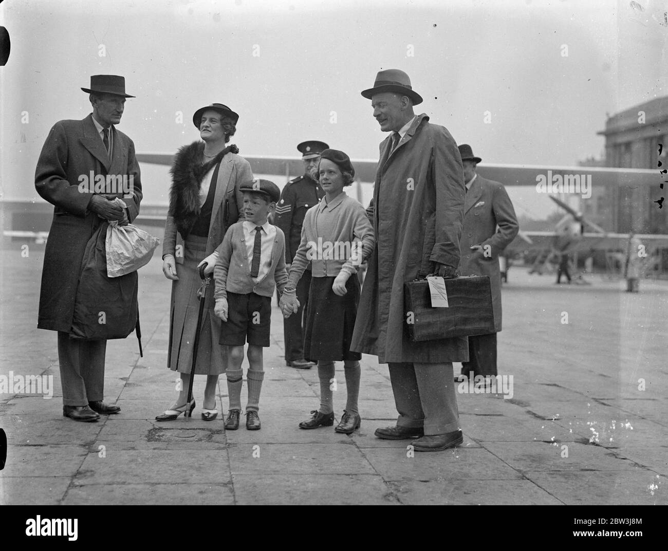 Air Chief Marshal welcomed by his children , when he arrives home from Middle East . Air Chief Marshal Sir Robert Brock Popham was welcomed by his wife and two children when he arrived at Croydon Aerodrome by air from the Middle East . Photo shows , Air Chief Marsshal Sir Robert Brock Popham embracing his two children on arrival at Croydon . 4 June 1936 Stock Photo