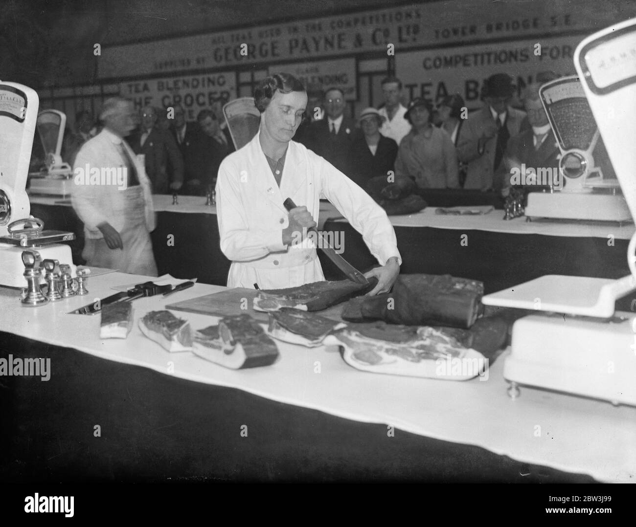 Girl competes for bacon cutting title at grocers exhibition for first time . Miss Elsie Price competing for the bacon cutting title at the Agricultural Hall . 24 September 1935 Stock Photo
