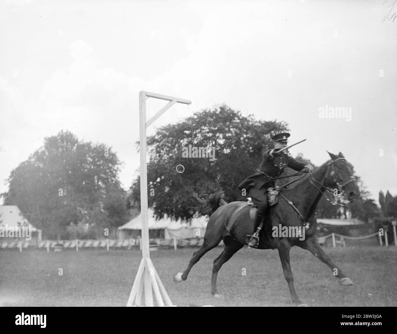 Police riders compete at Imber Court horse show . The Metropolitan Police Horse Show , in which crack police riders from all over the counrty are competing has opened at Imber Court , Twickenham , Middlesex . The show , the sixteenth , is the last at which the man who started it , Lieutenant Colonel , Sir Percy Laurie , Assistant Commisioner , attends in his official capacity , as he retires next week . Photo shows , a competitor in action in the ball and truncheon competition . 8 July 1936 Stock Photo