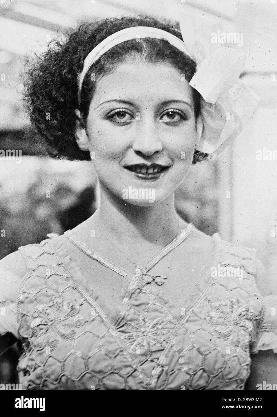 World beauty queens compete for  Miss Universe  title in Brussels . With dainty white dress and bow setting off her complexion to perfection , Miss Tunis prepares for the judges . 28 September 1935 Stock Photo