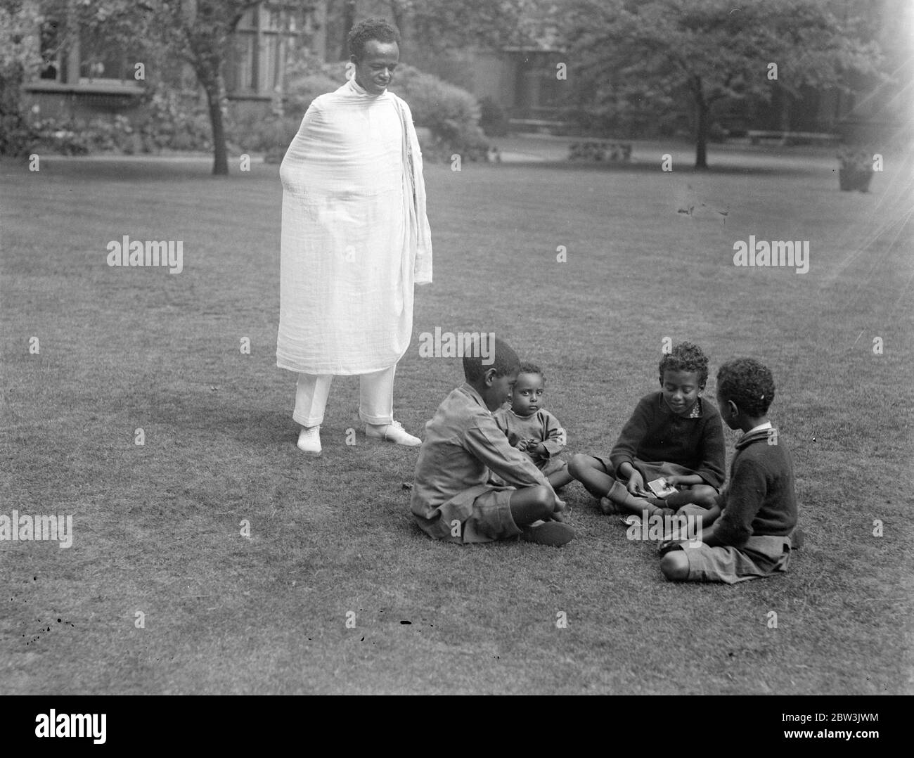Children of Abyssinian Minister read latest news of crisis . Four children of Dr Martin , the Abyssinian Minister in London , reading the latest news of their country 's dispute with Italy in the grounds of the Abyssinian Legation . 20 July 1935 Stock Photo