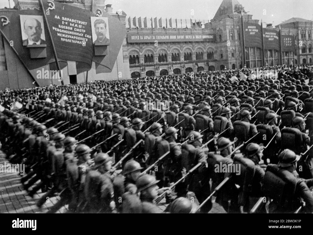 First pictures of May Day in Moscow . Thousands of fixed bayonets in Red Square parade .. May day was celebrated in Moscow with a display of Russia ' s military might in Red Square in honour of Stalin , the ' leader of the world ' s workers ' who watched from the roof of Lenin ' s tomb . Over 300 tanks , 30 , 000 troops of the Moscow garrison , including mechanised units , paraded past the tomb after being reviewed by Marshal Voroshiloff , Commissar for Defence . At the same time , the latest Soviet warplanes droned overhead . The display was watched by Lord Marley and other distinguished fore Stock Photo