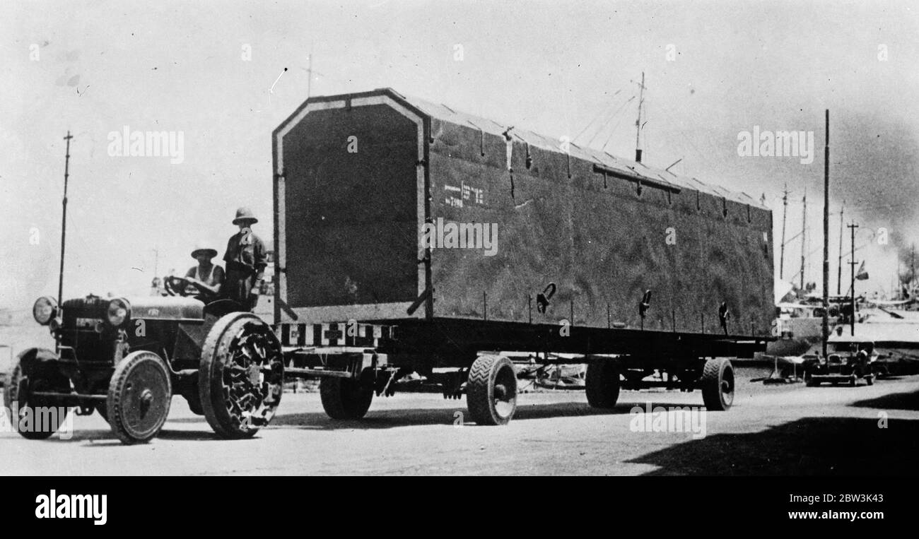 How Italy transports aircraft in East Africa . A gigantic motor van leaving the docks at Massawa , chief pot of Italian Eritres , loaded with Italian military planes just arrived in preparation for the campaign against Abyssinia . September 1935 Stock Photo