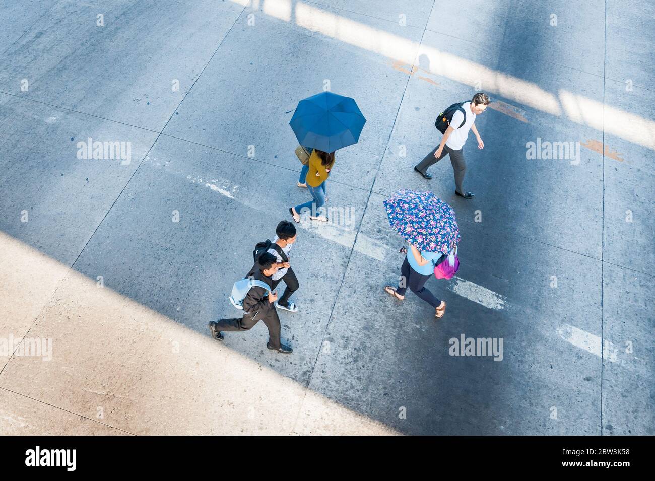 Shots of pedestrians. taxis, cars and jeepneys crossing the road junction next to SM Clark Mall, Angeles City Mall, The Philippines. Stock Photo