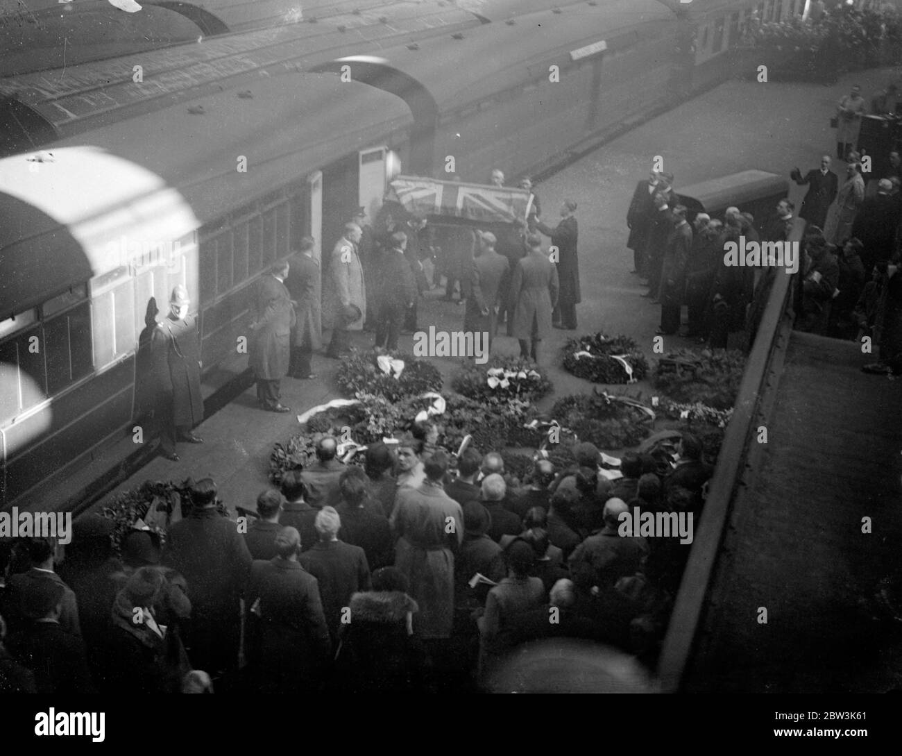 Bodies of five boys who lost their lives in mountain blizzards arrive in London . The bodies of the five London schoolboys who lost their lives in the blizzard on a Black Forrest mountain arrived at Liverpool Street Station after having been brought home from Freiburg , Germany . With the bodies were wreaths from Hitler , Sir Eric Phipps , the British Ambassador in Berlin and parents of the boys . Photo shows a coffin , draped with the Union Jack , being unloaded from the train at Liverpool station . 22 April 1936 Stock Photo