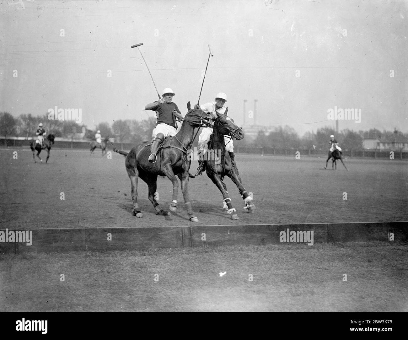 Texas rangers defeat panthers in Whitney Cup Polo Semi Final . Texas Rangers easily defeated the equally famous Panthers polo team in the semi final of the Whitney Cup at Hurlingham Club . Photo shows , Mr Cecil Smith of the Texas Rangers ( dark shirts ) and Mr H Salmon Backhouse ( Panthers ) charging for the bait . 13 May 1936 Stock Photo