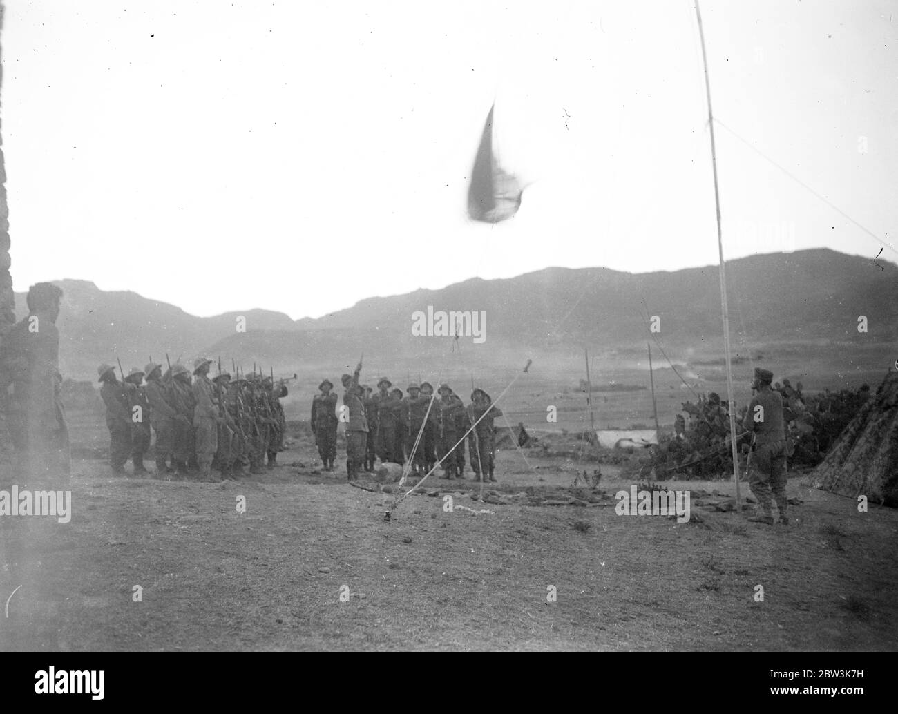 Hauling down the flag at sunset at Adigrat near old fort . May 1936 Stock Photo