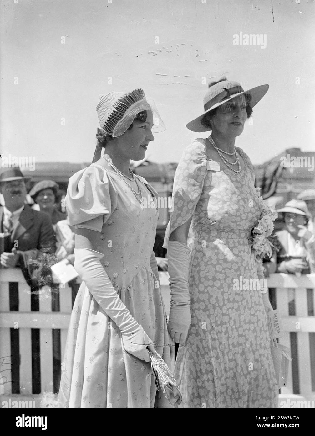 Musical hat fashion at Ascot . Ascot , on Royal Hunt Cup day , favoured with even better weather conditions then the opening , saw an even greater variety of lovely fashions . Photo shows , an unusual hat fashion worn with elbow length gloves by a woman racegoer at Ascot . 17 June 1936 Stock Photo