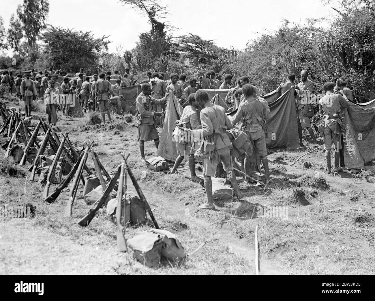 Ras Nasibu ' s army reported crushed by Graziani . the army of Ras Nasibu on the southern Abyssinian front is now reported to have been crushed by the Italian forces of General Graziani , which are now said to have take Jijiga , the key to Harar and the Addis Ababa Jibuti railway line . These photos of Ras Nasibu ' s army , which for months blocked the advances of the Italian forces in the south , were taken several months ago on the southern front and have never been published . Photo shows , Ras Nasibu ' s man putting up tents at a camp on the southern front . 20 April 1936 Stock Photo