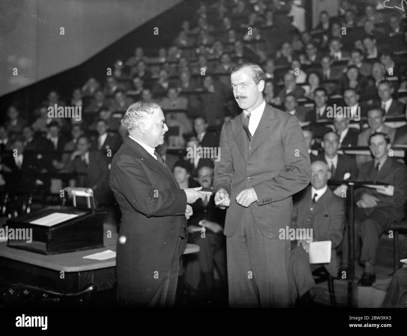 Minister of Health presents prizes at Guy 's Hospital Medical School , London . Sir Kingsley Wood presenting a medal for clinical surgery to P W Clarkson . 8 October 1935 Stock Photo