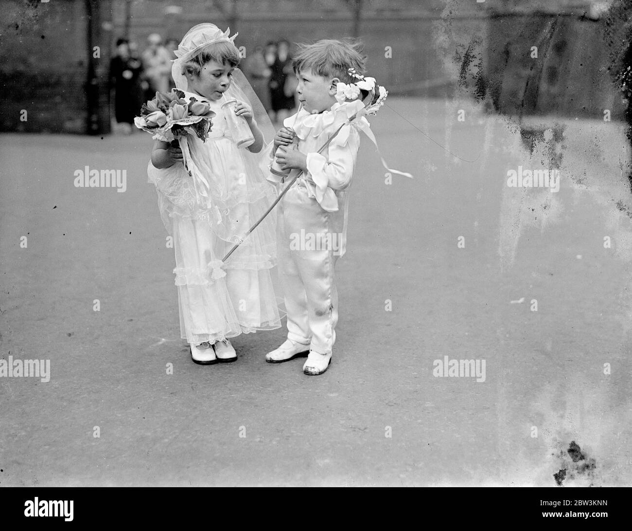 Five year old May Queen toasts May Day in milk ! . Five year old Pamela Tanner was elected one of 17 May Queens when May Day was celebrated at the Hugh Middleton School , Clerkenwell . Photo shows , Pamela Tanner , the May Queen , toasting May Day in milk with little Tony Slater , one of her attendants . 1 May 1936 Stock Photo