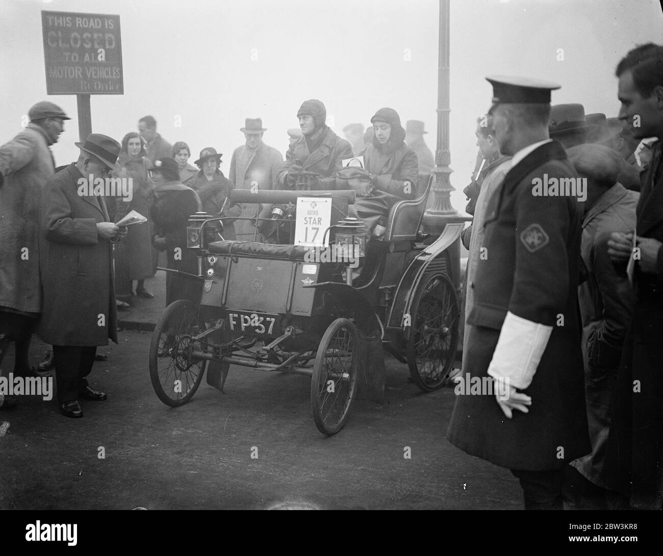 Annual old car run to Brighton starts in fog . In open cars and driving in thick fog , motorists started from The Magazine in Hyde Park , London , on the 41 annual Commemoration run to Brighton . The ' run ' , in which a record 116 cars , each at least 33 years old took part to celebhrate the emancipation of motorists . Before 1896 every motor propelled vehicle had to be preceded by a man with a red flag . Photo shows , F S Rowden ' s 1896 Star , one of the first built by the Star Company , starting from Hyde Park . 21 November 1937 Stock Photo