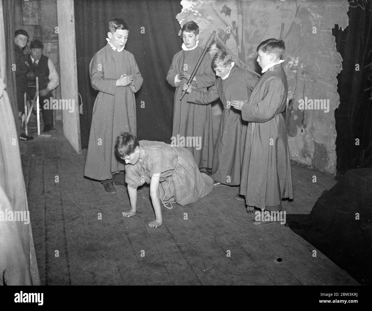 London ' s Boy Bishop whipped out of office . London ' s Boy Bishop , Fred Brazier , 12 year old chorister of St Mary of the Angels Song School ., Highgate , was whipped out of office by his fellow scholars in the dethronement ceremony at Hampstead . He was enthroned on St Nicholas Day . December 6 in the first public ceremony since the reformation . Photo shows , on hands and knees wearing sackcloth , the Boy Bishoip ( Fred Brazier ) is whipped out of office . 6 January 1936 Stock Photo