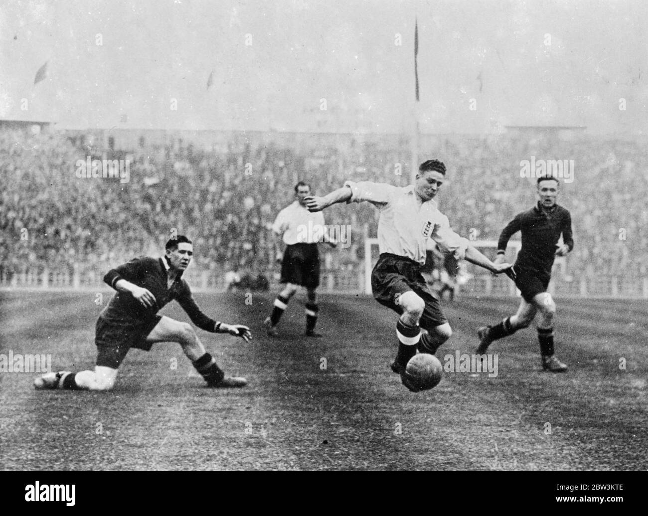 Belgium deals another soccer blow at England . Fresh from its defeat at the hands of Austria , the England football team had again to lower its colours in Brussels , where it was beaten by Belgium 3 , 2 . Photo shows an attack on the Belgium goal by George Camsell the England centre forward . 11 May 1936 Stock Photo