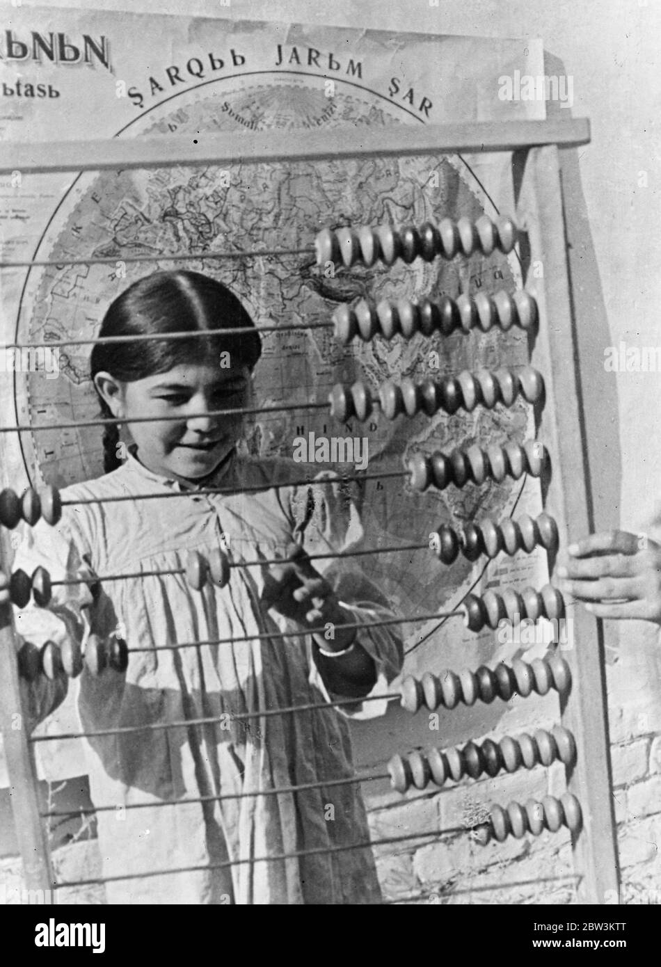 Russian children learn to calculate with the abacus , counting board of