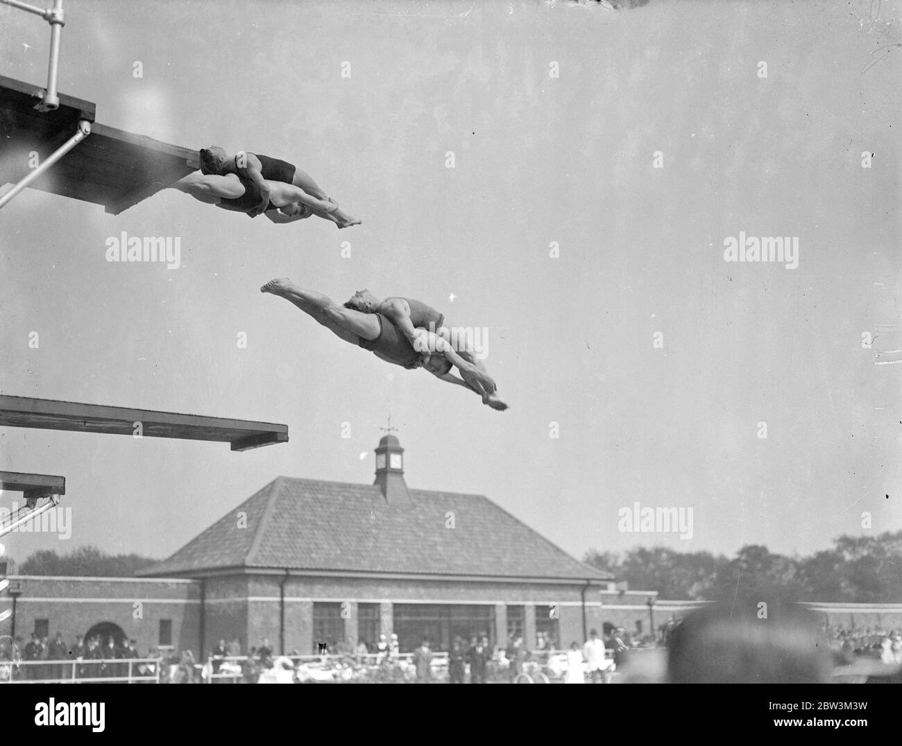 First plunge into new Victoria Park swimming pool . Mr Herbert Morrison , MP , Leader of the London County Council , opened the new open air swimming bath in Victoria Park . Photo shows , members of Highgate Diving club in mid air as they inaugurated the new pool . 16 May 1936 Stock Photo