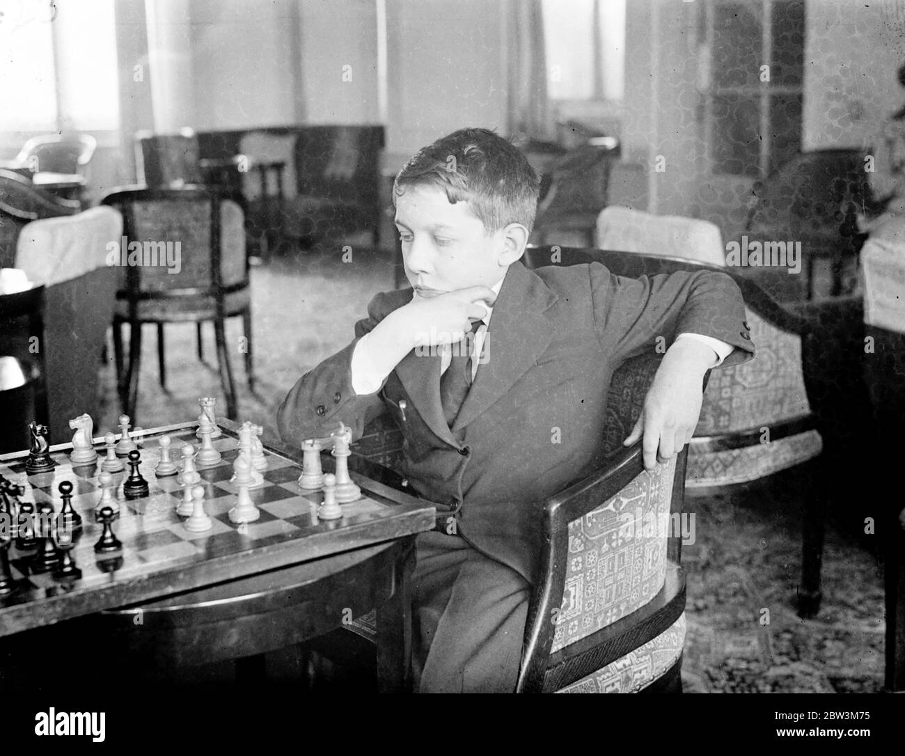 13 1 / 2 year old competitor in Margate chess congress . Chess champions from every part of the world are competing in the second annual Chess Congress which has opened at the Grand Hotel , Margate . One player has established a new record by travelling from the Philippine Islands to compete . The youngest competitor is Miss Elaine Saunders aged 10 . Photo shows , John Leach Lewis , aged 13 1 / 2 puzzles a move against Elaine Saunders . 16 April 1936 Stock Photo
