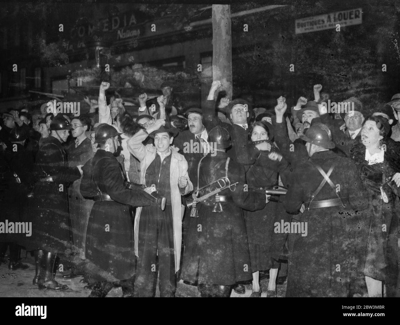 War veteran and right wingers in confrontation in Paris . There were fierce scuffles between demonstrators and police near the Arc de Triomphe in Paris when left wing war veterans came into conflict with right wing organisations marching up the Champs-Élysées during the Armistice celebrations . Many arrests were made and a number of combatants injured . Photo shows , members of the popular first norsaming defence as Mobile Guards push them back with rifles . 12 November 1935 Stock Photo