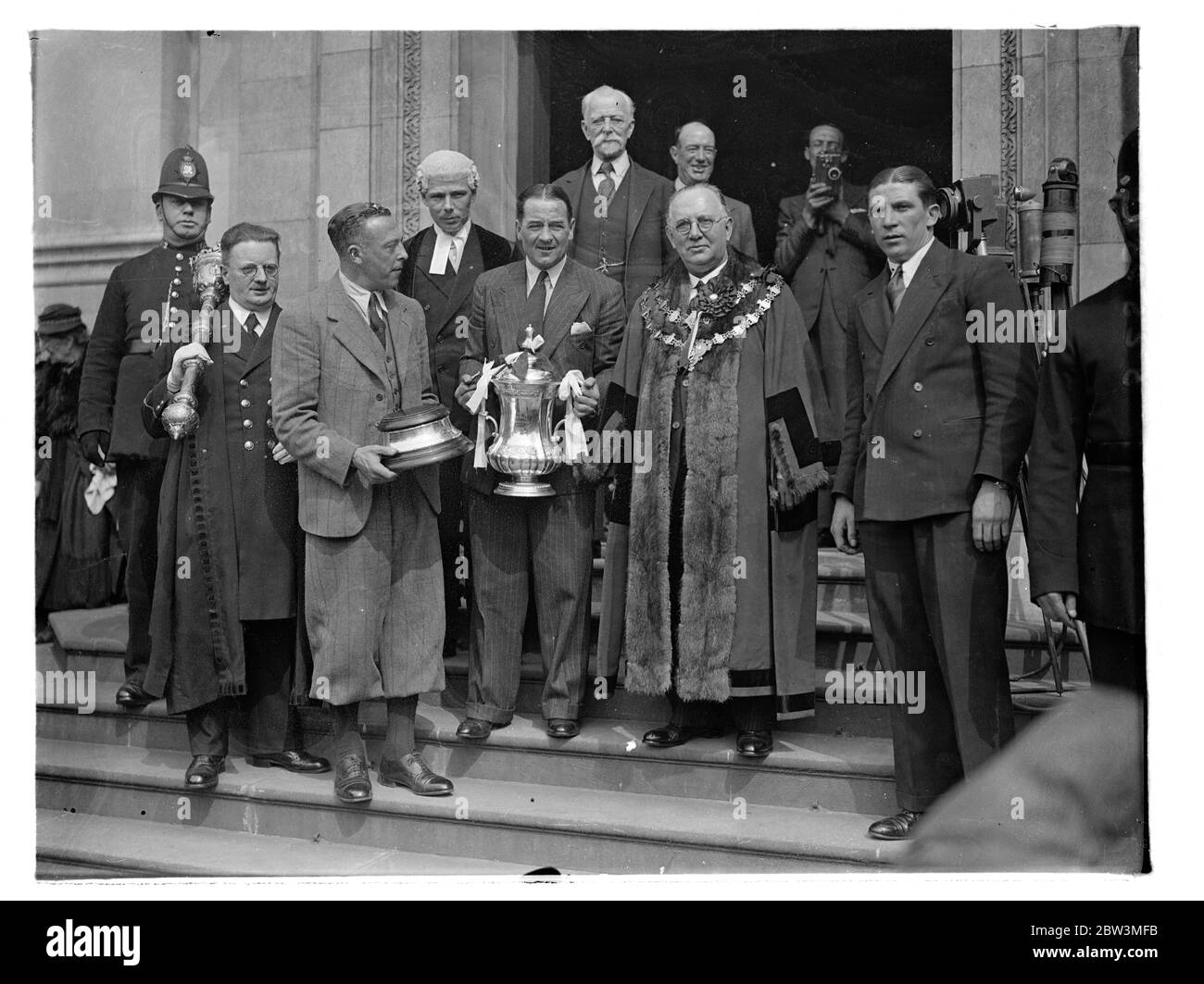 Arsenal team given civic reception at Islington . Drive through crowded streets . The Arsenal team , English Cup winners , carrying the F A Cup , drove through large crowds to the Islington Town Hall , where they were given a civic reception . The team was received by the Mayor , Councillor H G Coleman , himself an old footballer , at the town hall . Photo shows , Alex James , the Arsenal captain showing the cup to the crowd . Also in the picture is the Mayor of Islington , councillor H G Coleman . 28 April 1936 Stock Photo